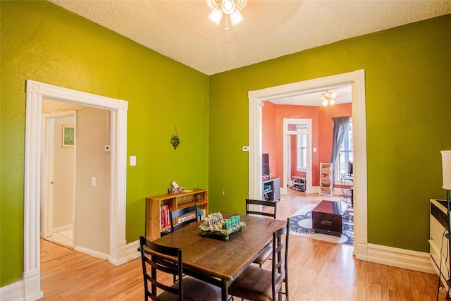 717 W Quartz St, Butte, MT 59701 - dining space with light wood-style floors, a textured ceiling, and baseboards