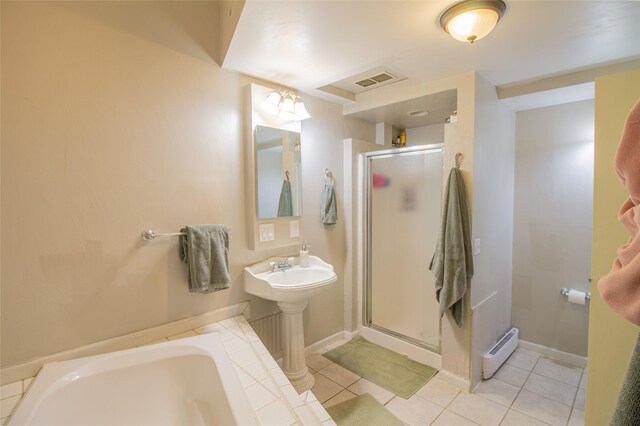 717 W Quartz St, Butte, MT 59701 - full bathroom featuring a baseboard heating unit, a shower stall, tile patterned flooring, a bath, and baseboards