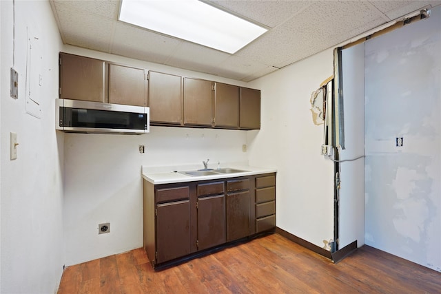21 N Last Chance Gulch Gulch Unit 3L, Helena, MT 59601 - kitchen featuring stainless steel microwave, a sink, a drop ceiling, wood finished floors, and light countertops