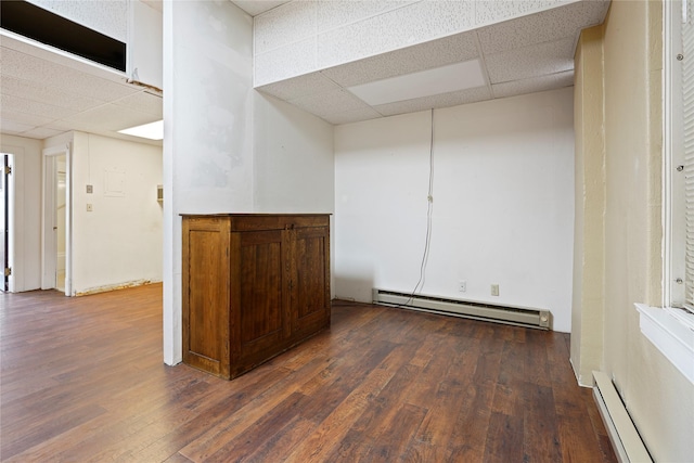 21 N Last Chance Gulch Gulch Unit 3L, Helena, MT 59601 - empty room featuring a drop ceiling, a baseboard heating unit, and dark wood-style floors