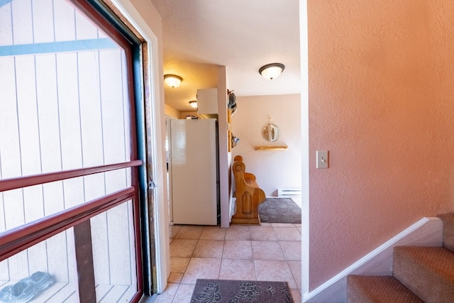 102 Scenery Rd, Libby, MT 59923 - hall featuring a textured wall, stairway, and light tile patterned floors