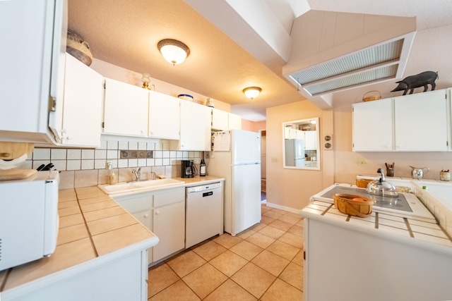 102 Scenery Rd, Libby, MT 59923 - kitchen with white appliances, a sink, decorative backsplash, and white cabinetry