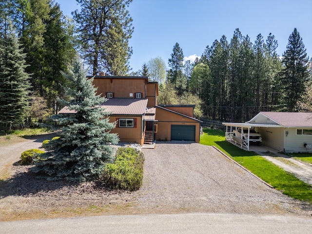 102 Scenery Rd, Libby, MT 59923 - view of front of house featuring driveway, metal roof, a garage, and a carport