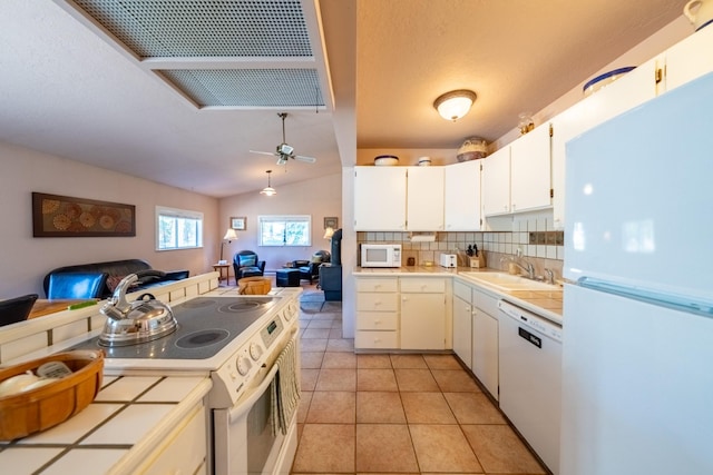 102 Scenery Rd, Libby, MT 59923 - kitchen with white appliances, a sink, tile countertops, open floor plan, and decorative backsplash