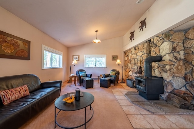102 Scenery Rd, Libby, MT 59923 - living area featuring a wood stove, lofted ceiling, and light colored carpet