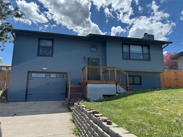 bi-level home with an attached garage, concrete driveway, stairway, and a chimney