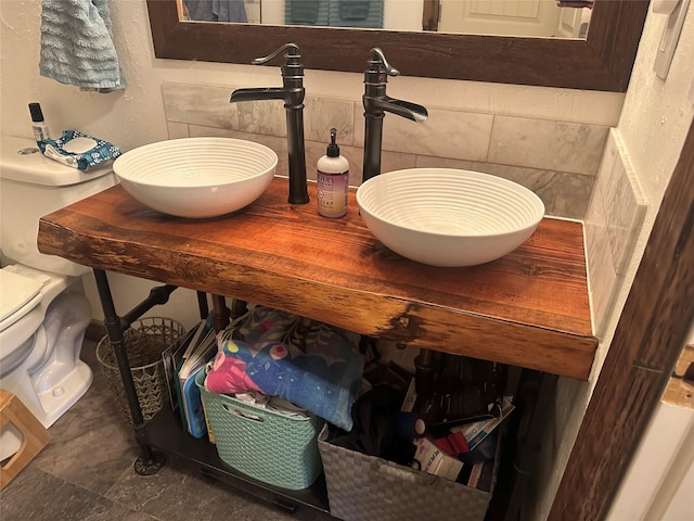 bathroom view of backsplash and toilet