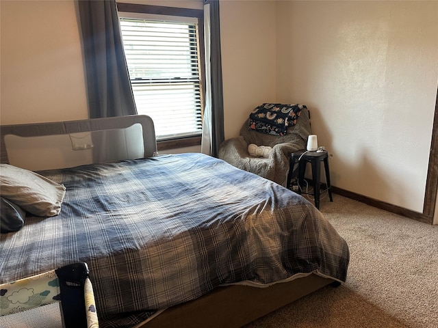 bedroom featuring carpet floors and baseboards
