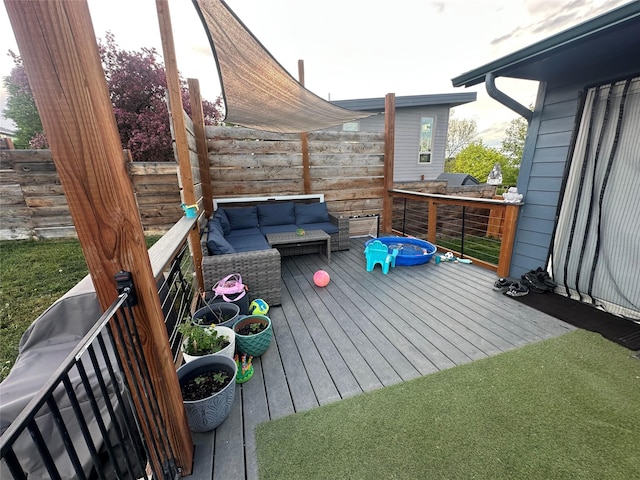 wooden terrace featuring an outdoor hangout area and fence