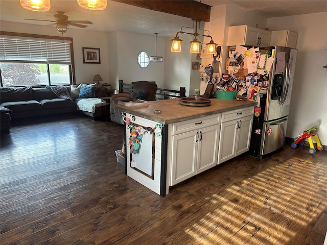 kitchen with a ceiling fan, open floor plan, dark wood-style flooring, and hanging light fixtures