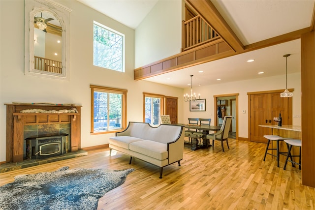 10758 Sleeman Creek Rd, Lolo, MT 59847 - living area featuring wood finished floors, recessed lighting, a wood stove, baseboards, and a towering ceiling