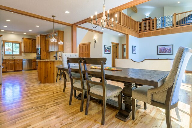 10758 Sleeman Creek Rd, Lolo, MT 59847 - dining space featuring light wood-style flooring, a chandelier, recessed lighting, and a high ceiling