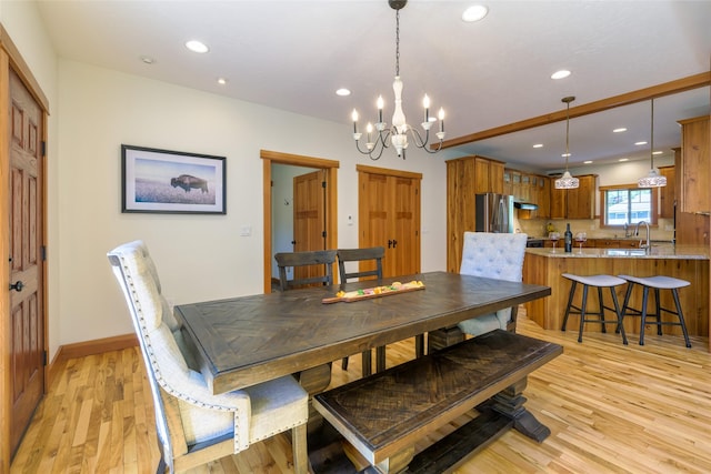10758 Sleeman Creek Rd, Lolo, MT 59847 - dining area with a chandelier, recessed lighting, light wood-style floors, and baseboards