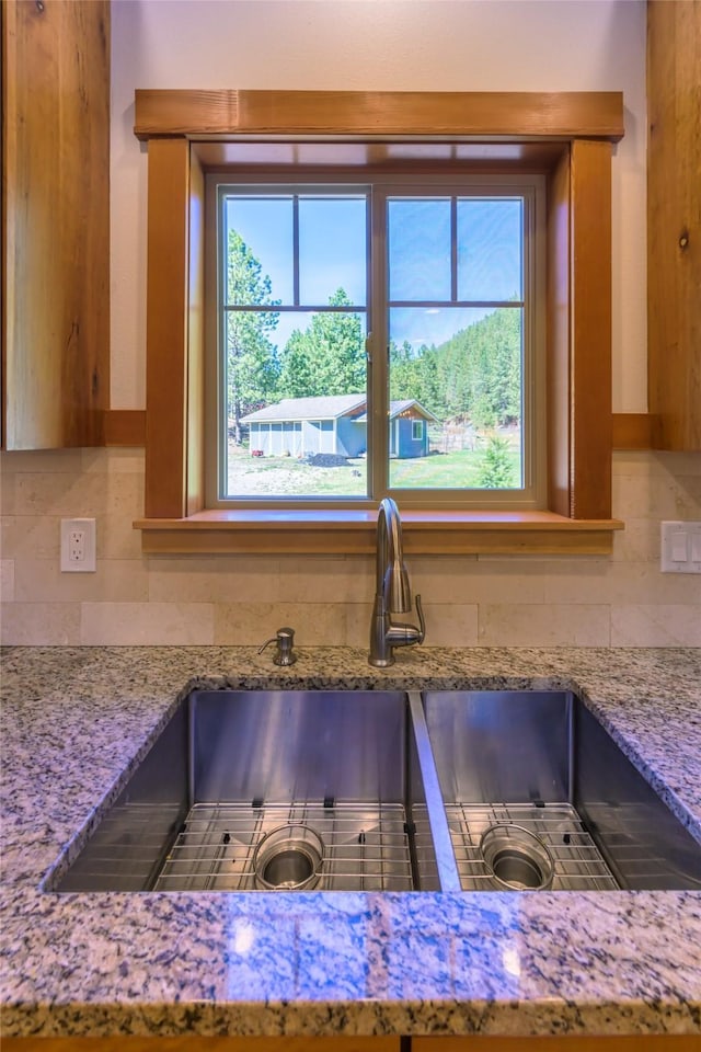 10758 Sleeman Creek Rd, Lolo, MT 59847 - kitchen view of a sink, backsplash, and light stone countertops