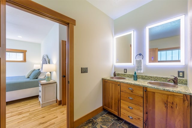10758 Sleeman Creek Rd, Lolo, MT 59847 - full bathroom with baseboards, connected bathroom, and double vanity