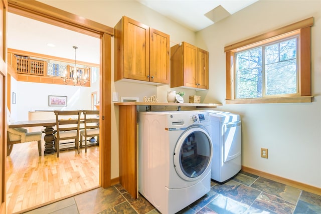 10758 Sleeman Creek Rd, Lolo, MT 59847 - laundry area with independent washer and dryer, a chandelier, cabinet space, and baseboards