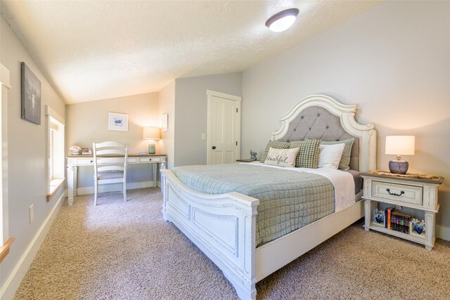 10758 Sleeman Creek Rd, Lolo, MT 59847 - bedroom with vaulted ceiling, light colored carpet, an office area, baseboards, and a textured ceiling