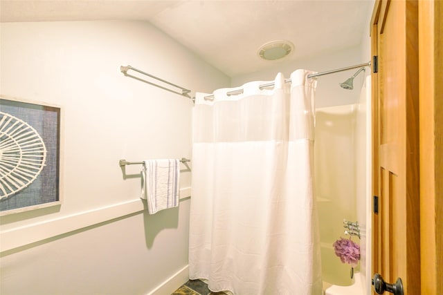 10758 Sleeman Creek Rd, Lolo, MT 59847 - bathroom featuring lofted ceiling and shower / bath combo with shower curtain
