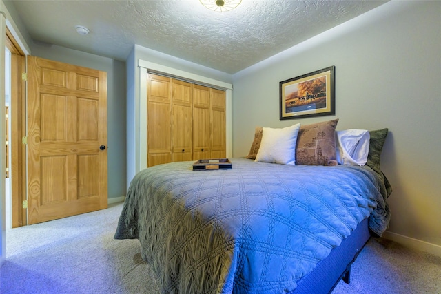 10758 Sleeman Creek Rd, Lolo, MT 59847 - bedroom with carpet flooring, a closet, and a textured ceiling