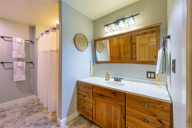 10758 Sleeman Creek Rd, Lolo, MT 59847 - bathroom featuring stone finish flooring, baseboards, vanity, and a shower with curtain