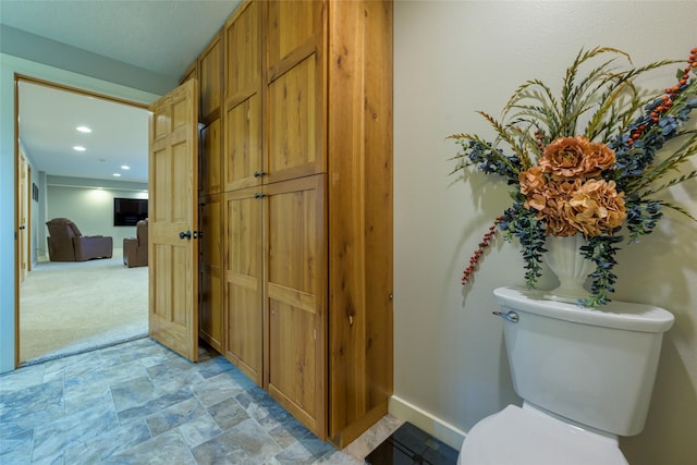 10758 Sleeman Creek Rd, Lolo, MT 59847 - bathroom with toilet, stone finish flooring, baseboards, and recessed lighting