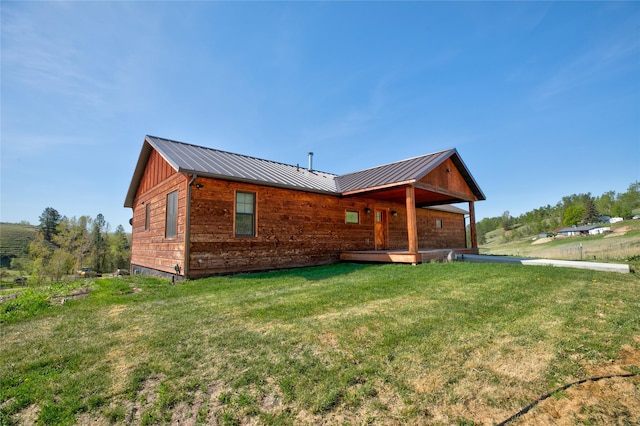 668 Dry Gulch Rd, Stevensville, MT 59870 - back of house with a lawn, metal roof, and a standing seam roof