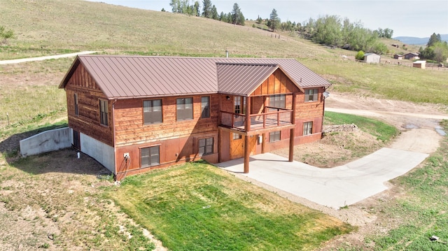 668 Dry Gulch Rd, Stevensville, MT 59870 - back of property with metal roof, a standing seam roof, and a balcony