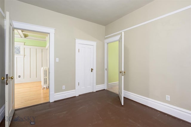 843 Lewisohn St, Butte, MT 59701 - unfurnished bedroom with radiator heating unit, wood finished floors, and baseboards