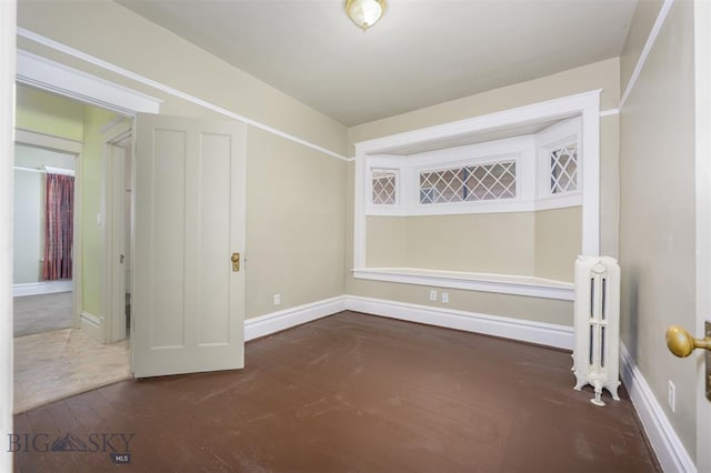 843 Lewisohn St, Butte, MT 59701 - empty room with radiator, baseboards, and wood-type flooring