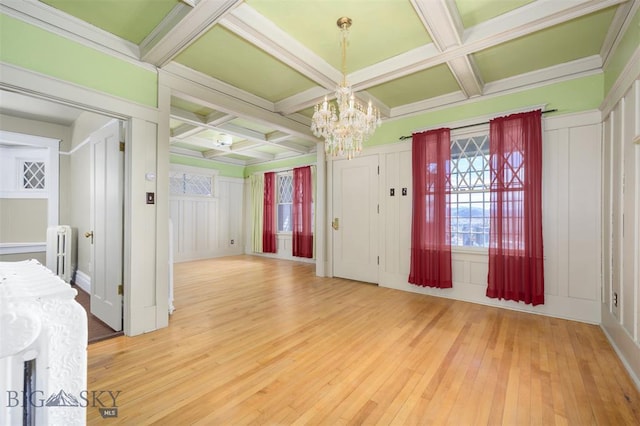 843 Lewisohn St, Butte, MT 59701 - unfurnished dining area featuring radiator, a chandelier, coffered ceiling, light wood-style flooring, and beamed ceiling