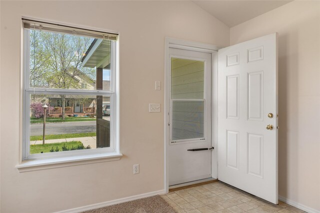 550 Green Tree Dr, Belgrade, MT 59714 - doorway to outside with baseboards, lofted ceiling, and light tile patterned flooring