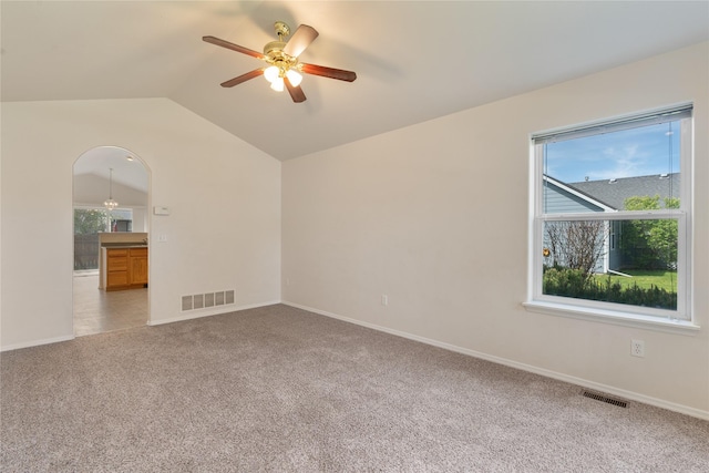 550 Green Tree Dr, Belgrade, MT 59714 - unfurnished room with light carpet, ceiling fan, plenty of natural light, vaulted ceiling, and baseboards
