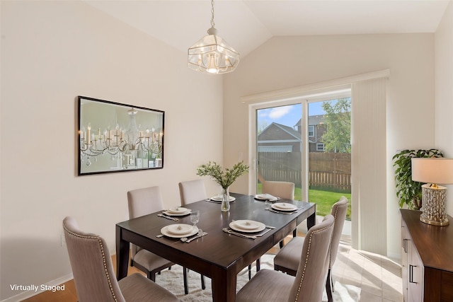 550 Green Tree Dr, Belgrade, MT 59714 - dining room with vaulted ceiling, a chandelier, and baseboards