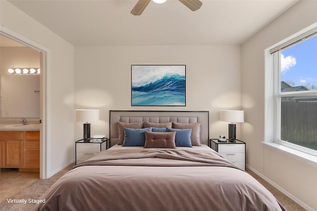 550 Green Tree Dr, Belgrade, MT 59714 - bedroom with a sink, baseboards, ensuite bath, a ceiling fan, and light tile patterned flooring