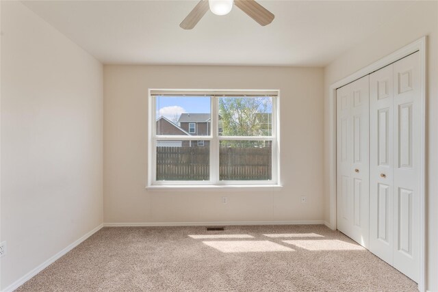 550 Green Tree Dr, Belgrade, MT 59714 - unfurnished bedroom featuring carpet, a closet, baseboards, and a ceiling fan