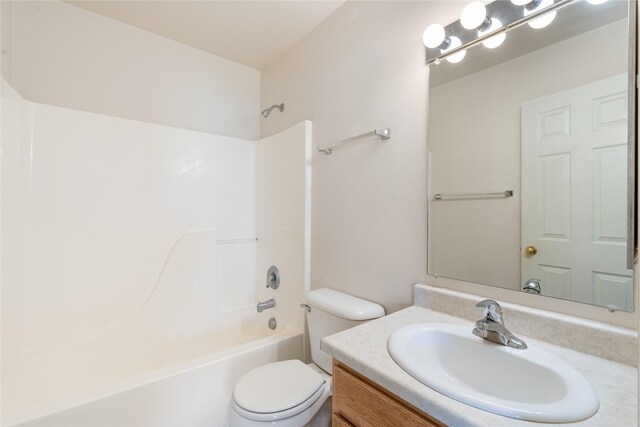 550 Green Tree Dr, Belgrade, MT 59714 - bathroom featuring toilet, vanity, and washtub / shower combination