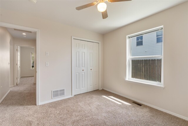 550 Green Tree Dr, Belgrade, MT 59714 - unfurnished bedroom featuring carpet flooring, baseboards, a closet, and a ceiling fan