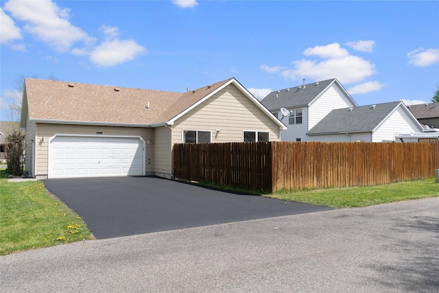 550 Green Tree Dr, Belgrade, MT 59714 - view of front of property featuring fence, an attached garage, and asphalt driveway
