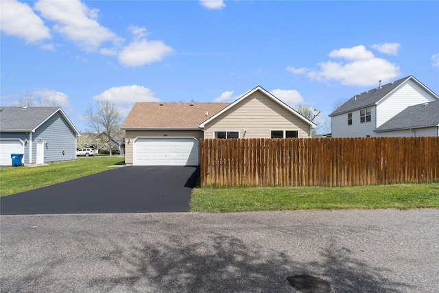 550 Green Tree Dr, Belgrade, MT 59714 - view of front facade featuring driveway, fence, and a garage