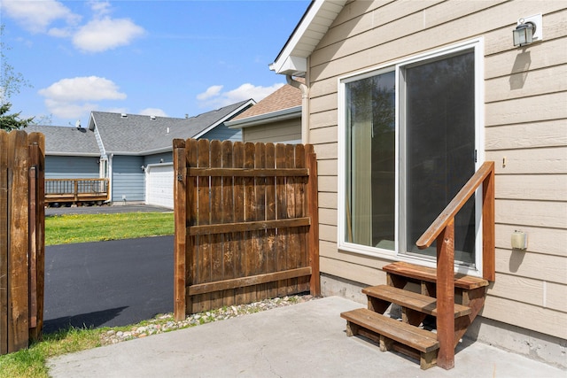 550 Green Tree Dr, Belgrade, MT 59714 - view of patio featuring entry steps, fence, and a garage