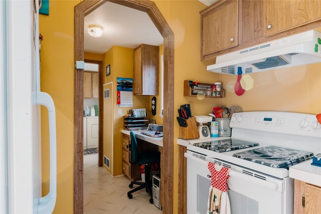 4242 Morningside Cir, Great Falls, MT 59405 - kitchen featuring white electric stove, under cabinet range hood, washer / clothes dryer, light flooring, and brown cabinetry