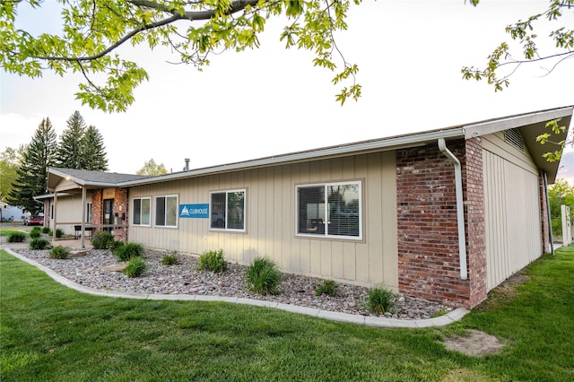 4242 Morningside Cir, Great Falls, MT 59405 - view of home's exterior with brick siding and a yard