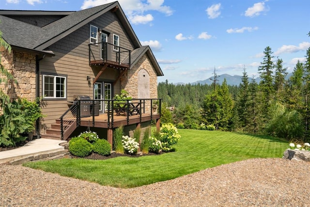 15 Sandi Ln, Heron, MT 59844 - back of house with stone siding, a balcony, a yard, and a deck with mountain view