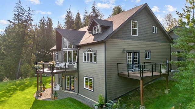 15 Sandi Ln, Heron, MT 59844 - back of house featuring a wooden deck, a yard, a chimney, and roof with shingles