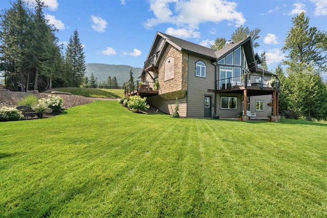 15 Sandi Ln, Heron, MT 59844 - rear view of house with a deck with mountain view and a lawn