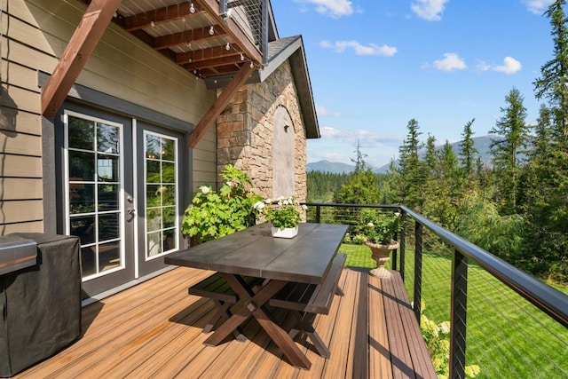 15 Sandi Ln, Heron, MT 59844 - wooden terrace with french doors, a mountain view, and a lawn