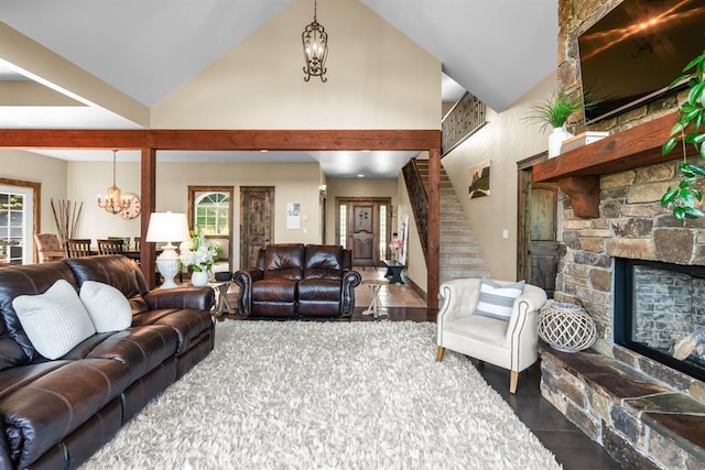 15 Sandi Ln, Heron, MT 59844 - living room with a chandelier, a stone fireplace, high vaulted ceiling, and stairway