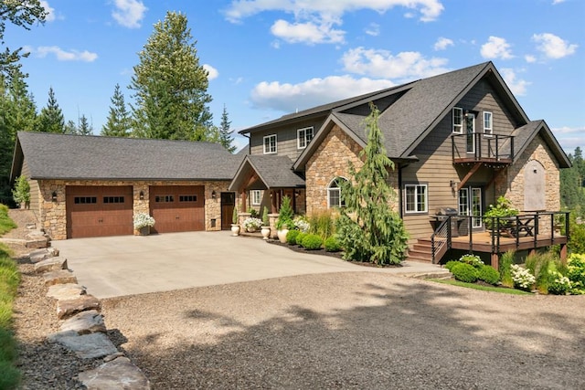 15 Sandi Ln, Heron, MT 59844 - craftsman-style home with stone siding, concrete driveway, a balcony, a shingled roof, and a deck