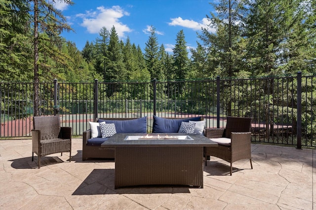 32 Alder Way Unit 4C, Whitefish, MT 59937 - view of patio featuring an outdoor living space with a fire pit and a view of trees