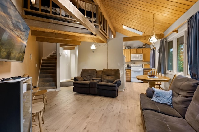 32 Alder Way Unit 4C, Whitefish, MT 59937 - living room featuring vaulted ceiling, stairs, light wood-type flooring, and wooden ceiling
